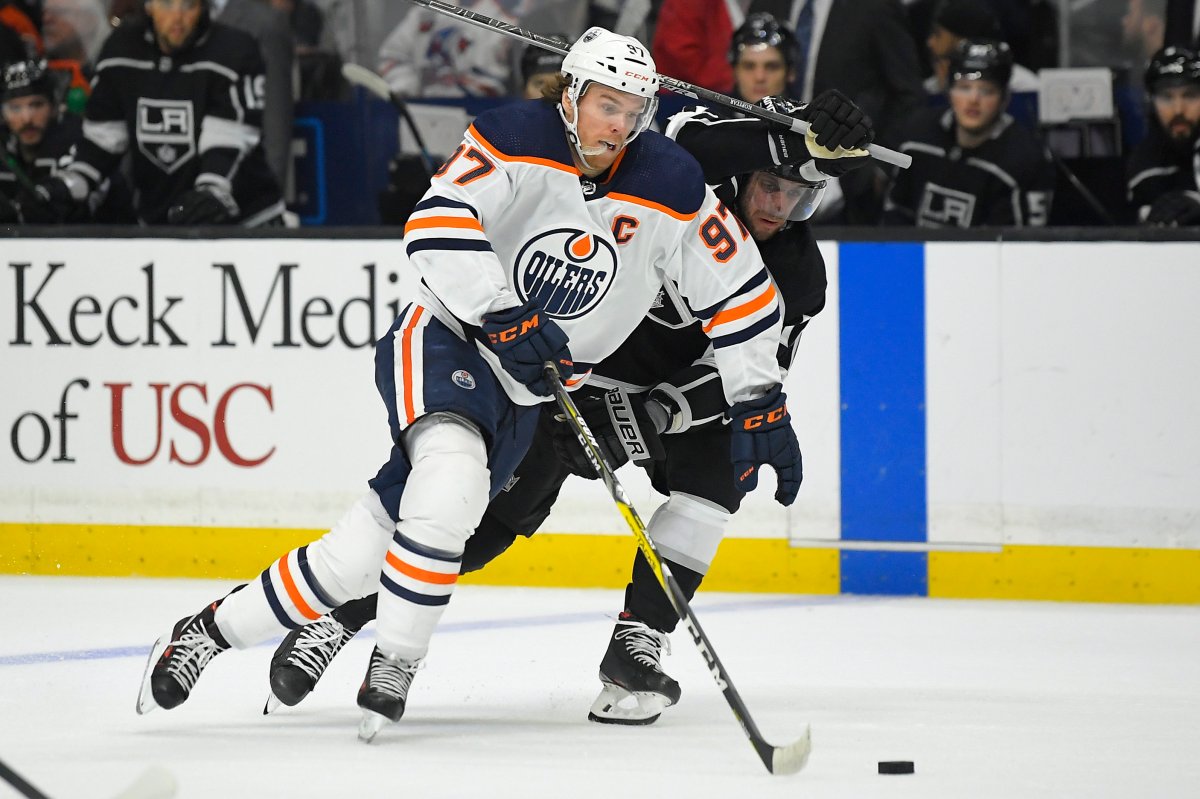 Edmonton Oilers center Connor McDavid, left, moves the puck while under pressure from Los Angeles Kings center Anze Kopitar during the first period of an NHL hockey game Sunday, Feb. 23, 2020, in Los Angeles. (AP Photo/Mark J. Terrill).