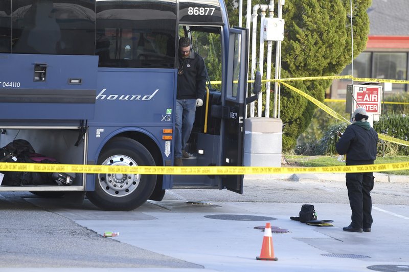 Investigators are seen outside of a Greyhound bus after a passenger was killed on board on Monday, Feb. 3, 2020 in Lebec, Calif.
