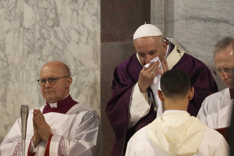 In this picture taken Wednesday, Feb. 26, 2020, Pope Francis wipes his nose during the Ash Wednesday Mass opening Lent, the forty-day period of abstinence and deprivation for Christians before Holy Week and Easter, inside the Basilica of Santa Sabina in Rome. Pope Francis is sick and skipped a planned Mass with Rome clergy across town on Thursday, Feb. 27, 2020, officials said. 