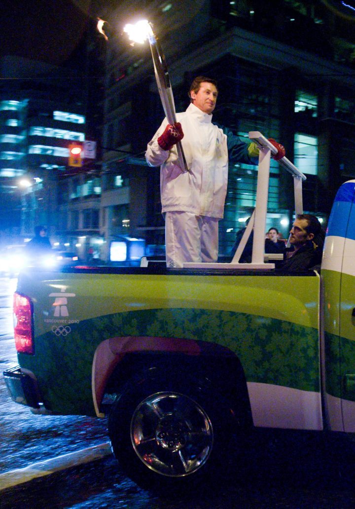Wayne Gretzky leaves B.C. Place with the Olympic Torch in Vancouver, B.C., Friday, Feb. 12, 2010 following the opening ceremony of the 2010 Vancouver Winter Olympic Games. THE CANADIAN PRESS/Geoff Howe