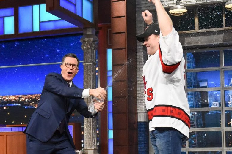 Stephen Colbert, left, sprays water on Carolina Hurricanes emergency goaltender David Ayres on ‘The Late Show’ on Feb. 24, 2020.