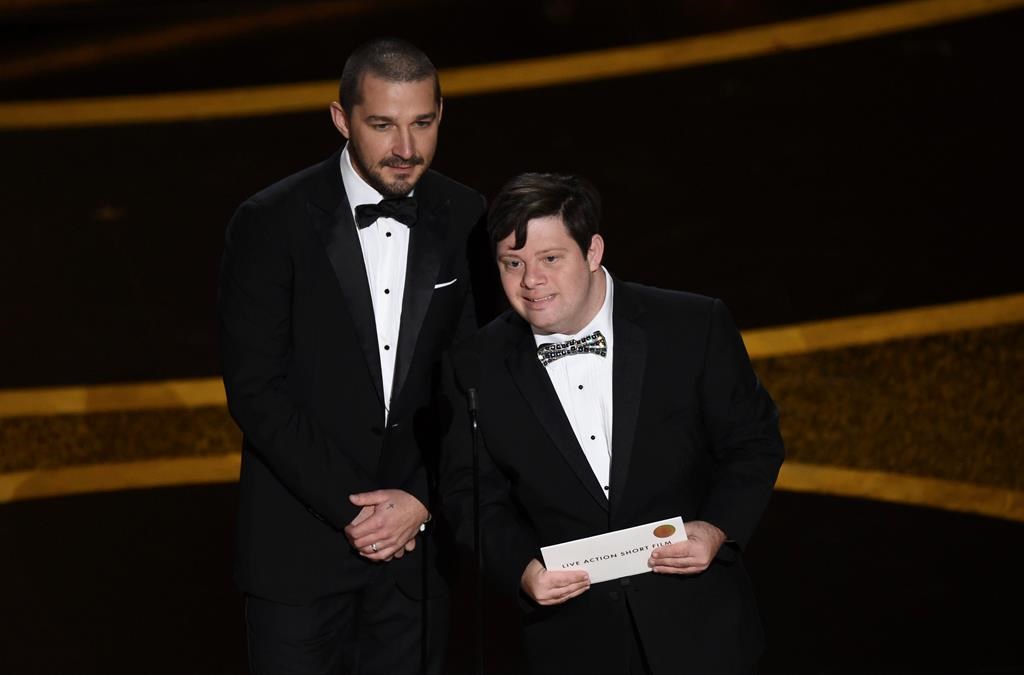 Shia LaBeouf, left, and Zack Gottsagen present the award for Best Live-Action Short Film at the Oscars on Sunday, Feb. 9, 2020, at the Dolby Theatre in Los Angeles. (AP Photo/Chris Pizzello)