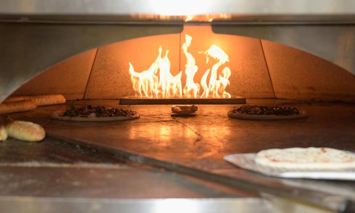 Pizzas made by Matt Sorum and Jane Lynch being cooked at a benefit of the Adopt The Arts school music and arts program at California Pizza Kitchen on September 29, 2018 in Century City, California.