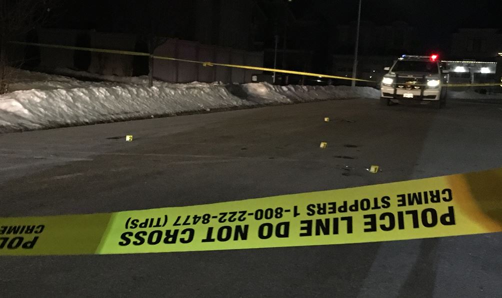 Evidence markers are placed near shell casings after a shooting in Aurora.