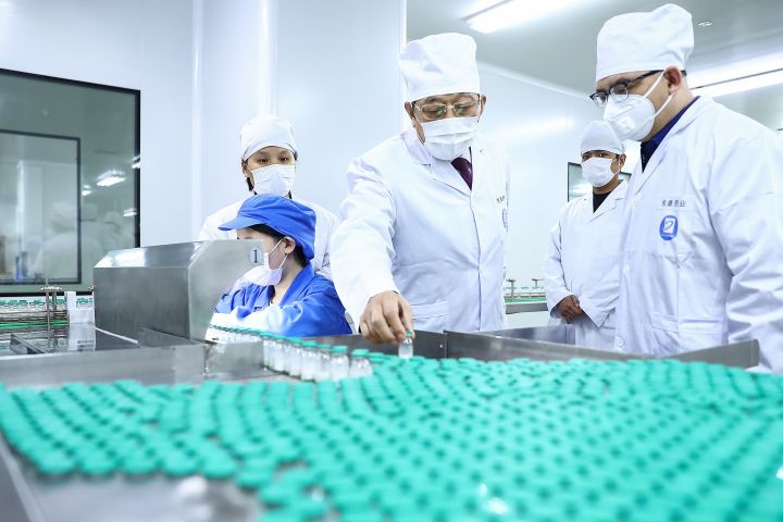 A manager checks the production of medicines in a workshop of Youcare Pharmaceutical Group CO., LTD in Beijing, Feb. 14, 2020. China is a major supplier in the global pharmaceutical market.