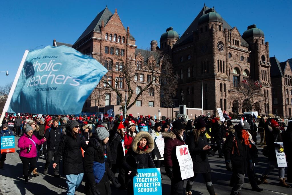 Protesters join a demonstration organized by the Teacher's Unions outside the Ontario Legislature, in Toronto, as four Teacher's Unions hold a province wide education strike, on Friday, February 21, 2020. THE CANADIAN PRESS/Chris Young.
