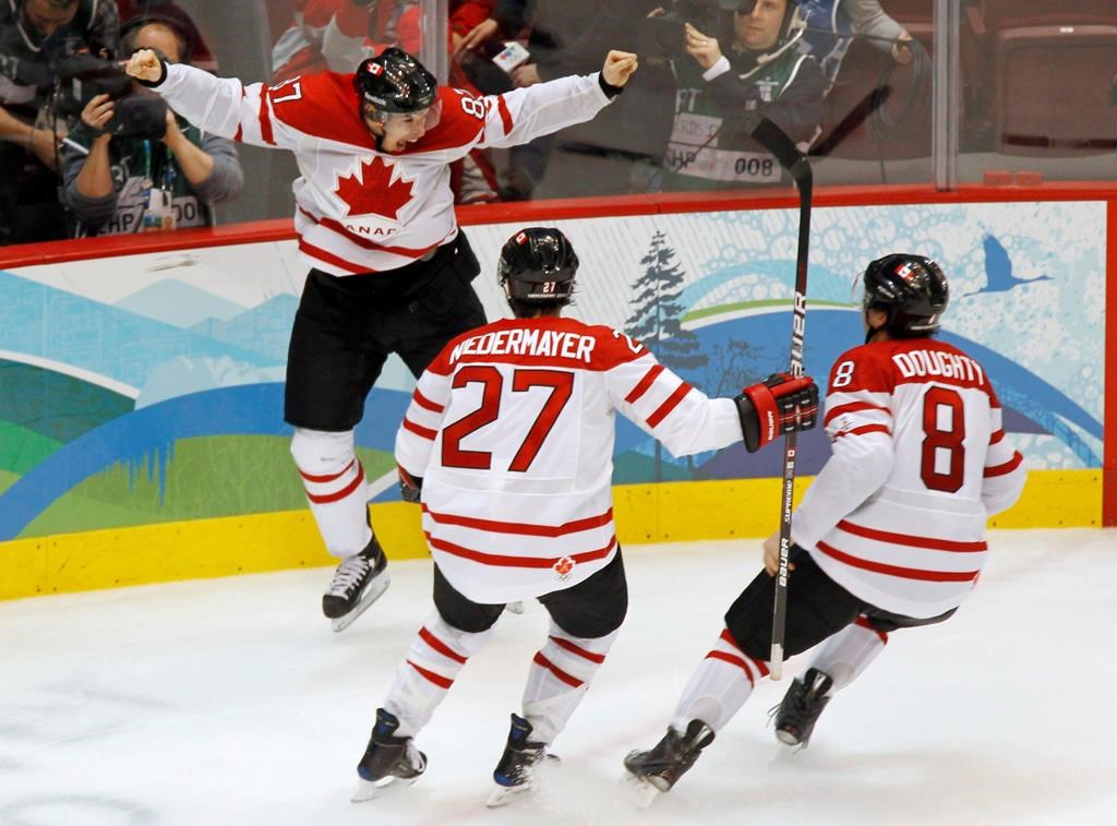 Canada's Sidney Crosby celebrates his game winning goal with Scott Niedermayer and Drew Doughty during overtime period men's ice hockey gold medal final at the 2010 Winter Olympic Games in Vancouver on February 28, 2010. Friday marks the 10th anniversary of Sidney Crosby's memorable overtime goal that lifted Canada past the United States 3-2 in the men's hockey final at the 2010 Vancouver Olympics. THE CANADIAN PRESS/Paul Chiasson.