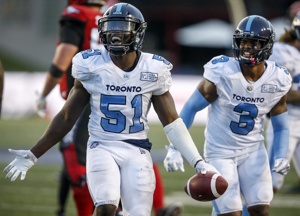 Toronto Argonauts' Micah Awe, celebrates making an interception as teammate Alden Darby, looks on during second half CFL football action against the Calgary Stampeders, in Calgary on July 18, 2019. The Winnipeg Blue Bombers signed American linebacker Micah Awe to a two-year contract Monday. The six-foot, 225-pound Awe had been on the free-agent market since Tuesday.