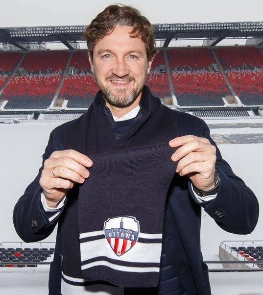 Miguel Angel Ferrer "Mista" poses with an Atletico Ottawa scarf after being named the inaugural head coach of the Canadian Premier League team in Ottawa on Tuesday, Feb. 11, 2020 in this handout photo.