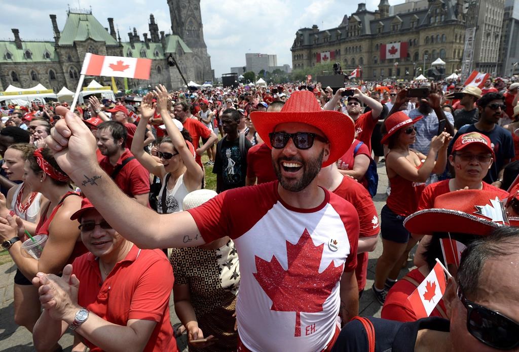 People cheer during Canada Day celebrations on Parliament Hill in Ottawa on Sunday, July 1, 2018. Canada's biggest annual birthday bash is being shifted away from Parliament Hill.
