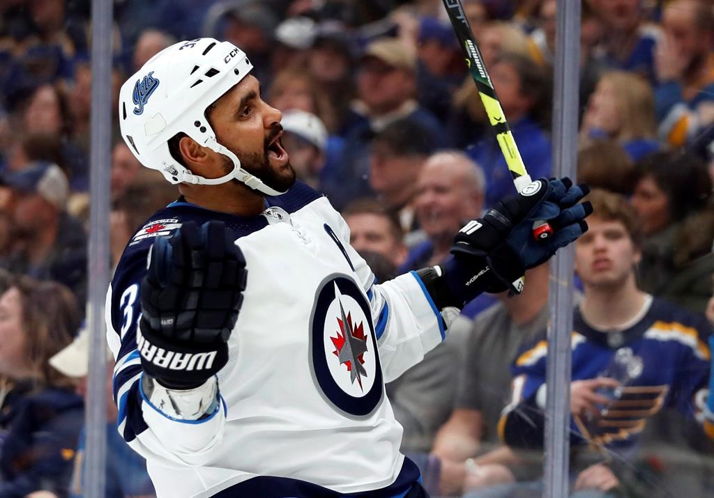 The Winnipeg Jets' Dustin Byfuglien celebrates after scoring during the third period in Game 3 of an NHL first-round hockey playoff series against the St. Louis Blues on Sunday, April 14, 2019, in St. Louis.