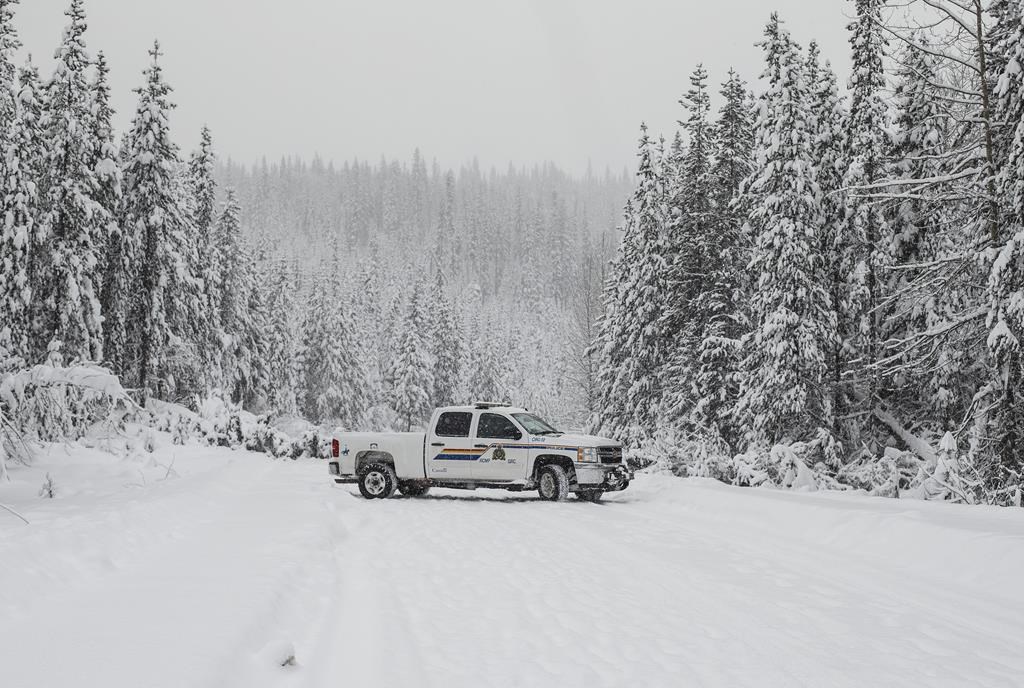 Police check out the blocked road leading to the Gidimt'en checkpoint near Houston B.C., on Thursday January 9, 2020. THE CANADIAN PRESS/Jason Franson.