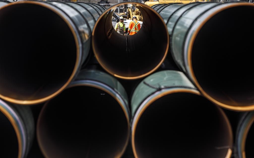 Pipe for the Trans Mountain pipeline is unloaded in Edson, Alta. on Tuesday June 18, 2019.