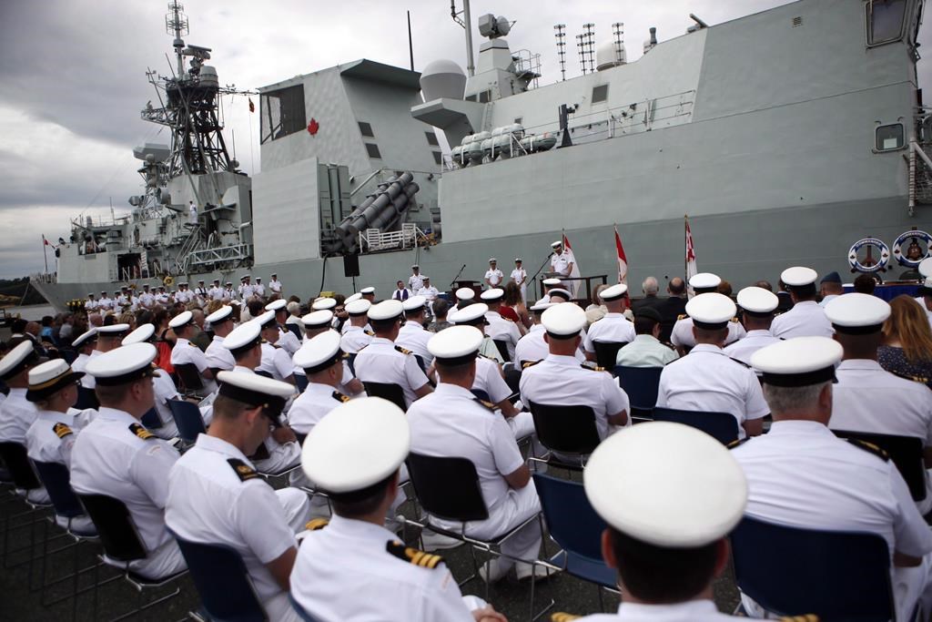The HMCS Calgary is seen behind sailors during a change of command ceremony at CFB Esquimalt, in Esquimalt, B.C., Wednesday, June 24, 2015.