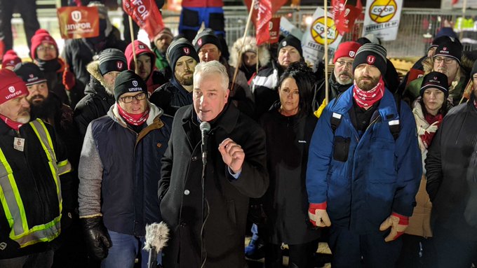Scott Doherty, executive assistant to the national president of Unifor, speaks to a crowd outside the Co-op Refinery Complex in Regina Friday night.