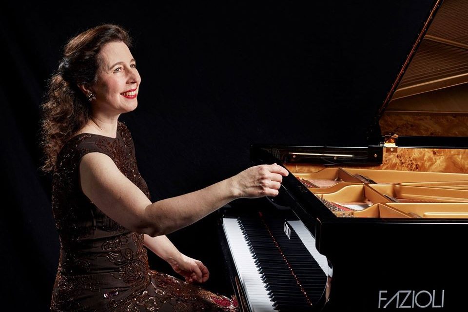 Canadian virtuoso Angela Hewit sits in front of her Fazioli piano in this promotional photo from 2019.