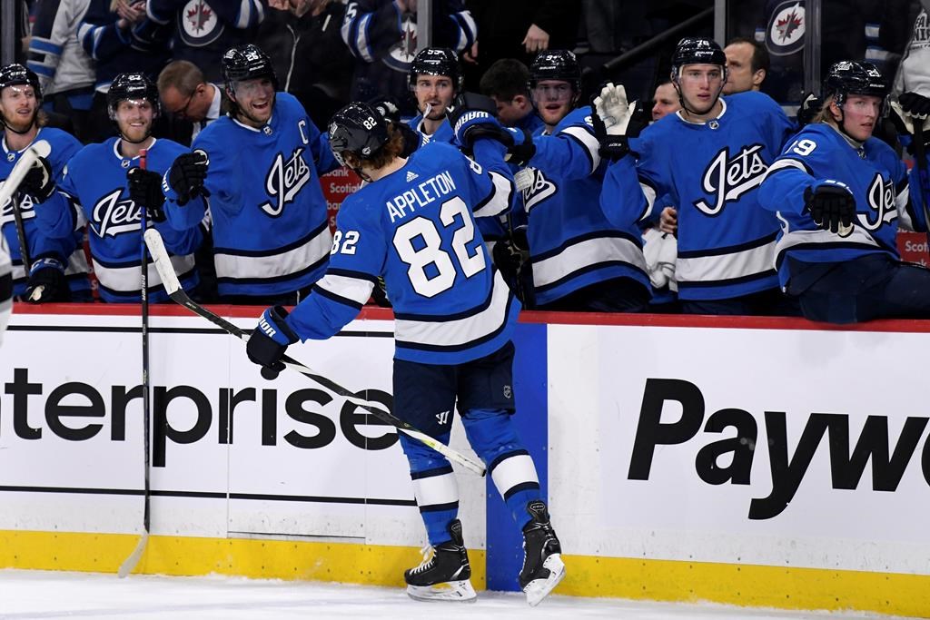 Winnipeg Jets' Mason Appleton (82) celebrates his goal with teammates on the bench during second-period NHL action against the Los Angeles Kings, in Winnipeg on Tuesday, Feb. 18, 2020.