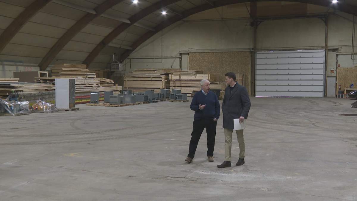 JR Film Studio owner Jim Walsh (left) walks through his empty film production centre in northeast Calgary.