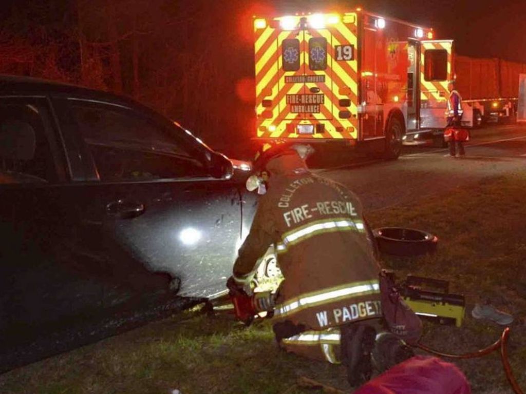 A woman dialed 911 with her toes after her hands were crushed while changing a tire.