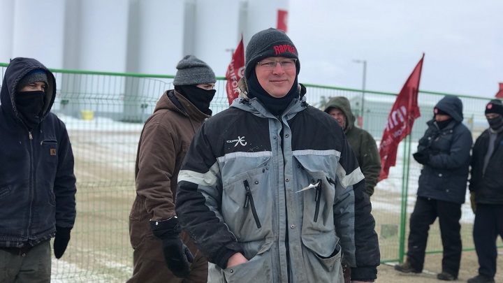 Karl Dahle stands in solidarity with Unifor members picketing outside a Co-op bulk storage facility near Moose Jaw, Sask. on Monday.
