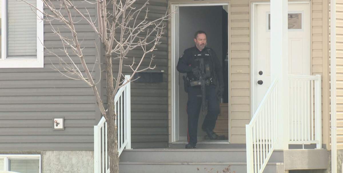 A Regina police officer is seen exiting a home following a complaint involving a firearm