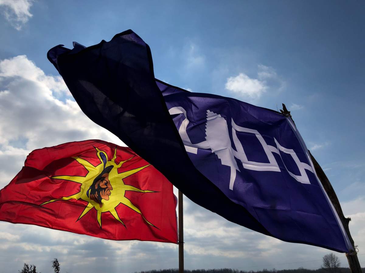 Indigenous flags are being flown down the road from a blockade set up near Belleville that has stopped rail traffic for the last seven days.