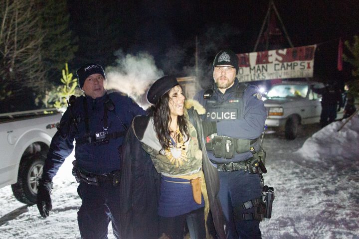 A demonstrator in Wet’suwet’en territory is detained by officers.