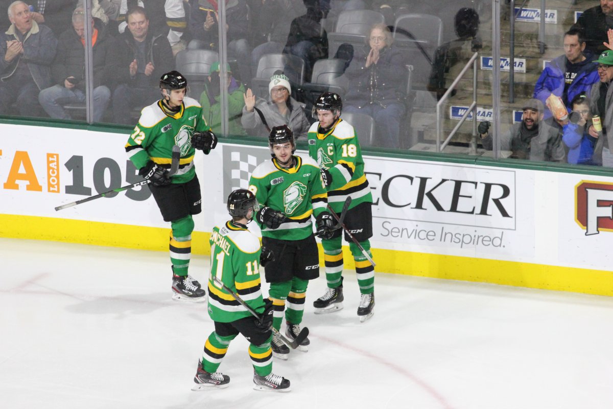 Ryan Merkley of the London Knights (28) is congratulated after scoring a goal by teammates Alec Regula (72), Liam Foudy (18) and Connor McMichael (11).