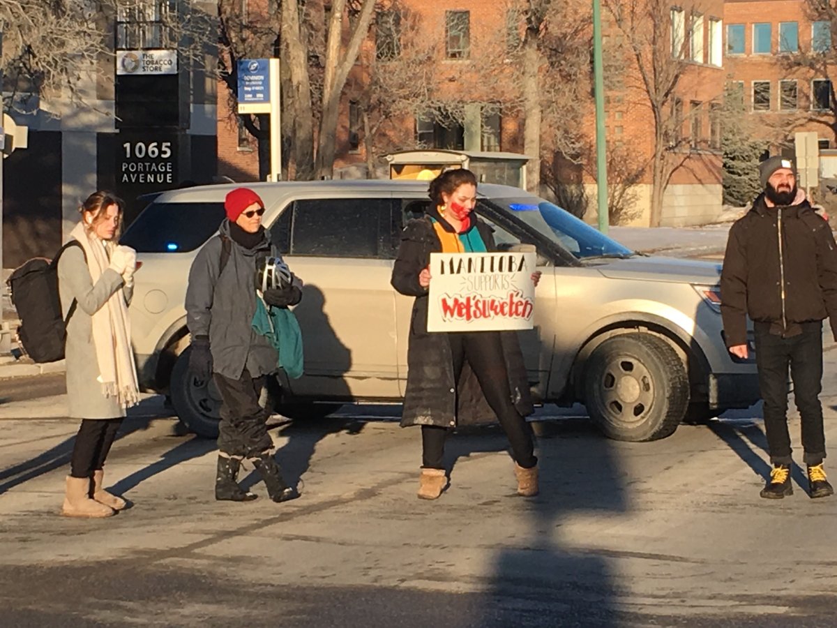 Protesters stopped traffic in front of RCMP headquarters in Winnipeg Monday.