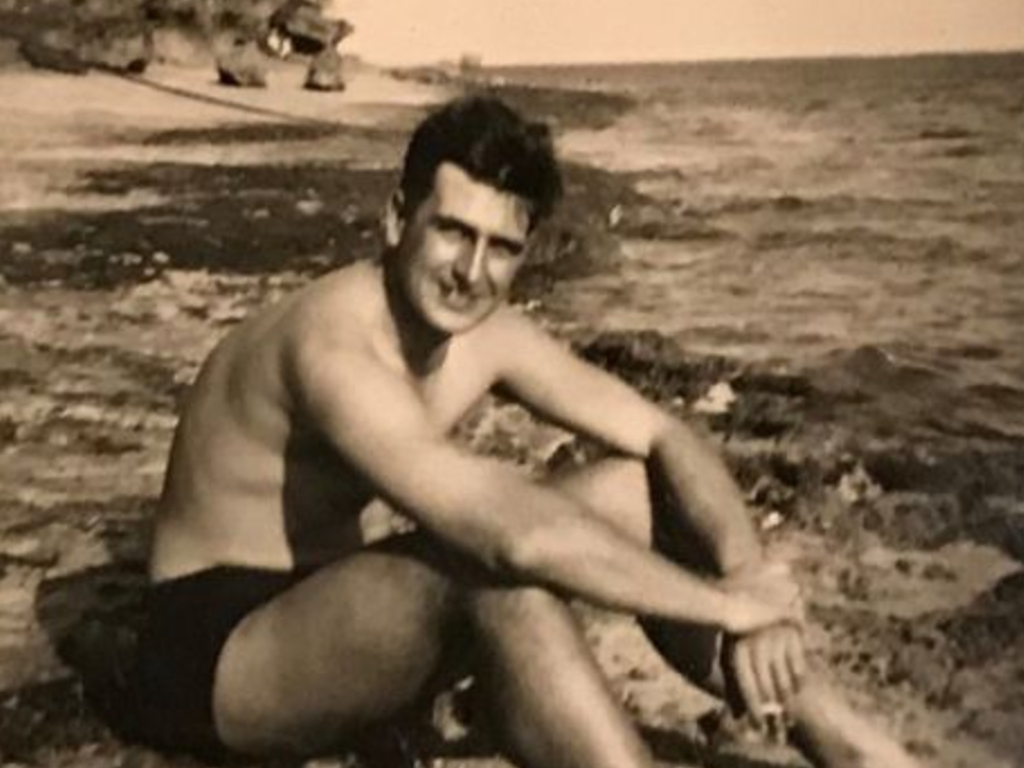John Stapleford, then 22, sitting on a beach in Mombasa in 1946 while serving in the Merchant Navy.