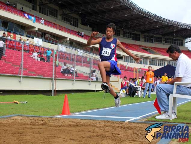 Jose Robles in the air as he competes in long jump.