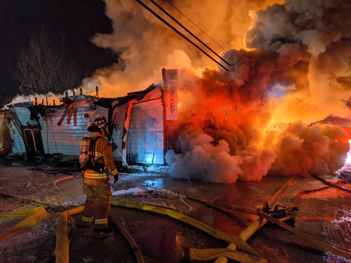 Ottawa firefighters spent hours tackling a three-alarm fire that collapsed the front of a restaurant in the city's rural south end early Monday morning.