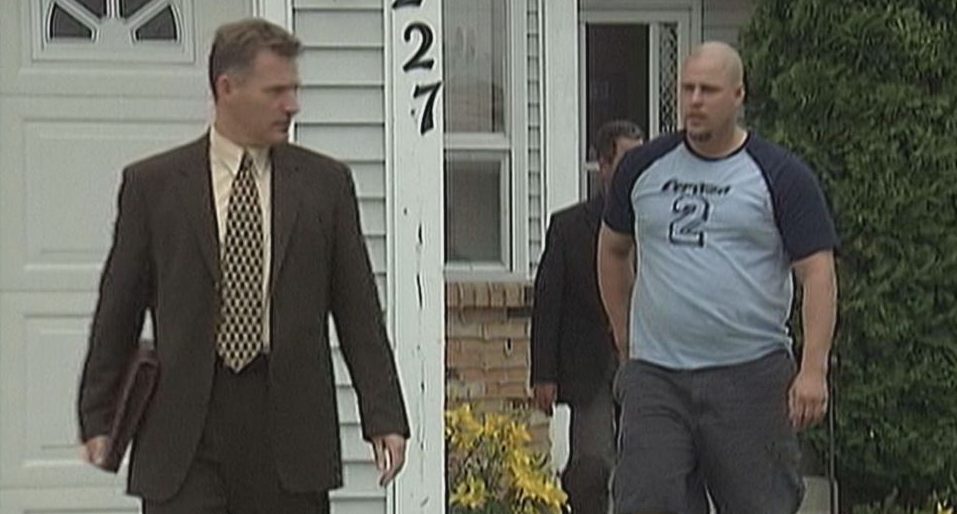 Michael White outside his Edmonton home before he was arrested for his wife's murder in 2005.