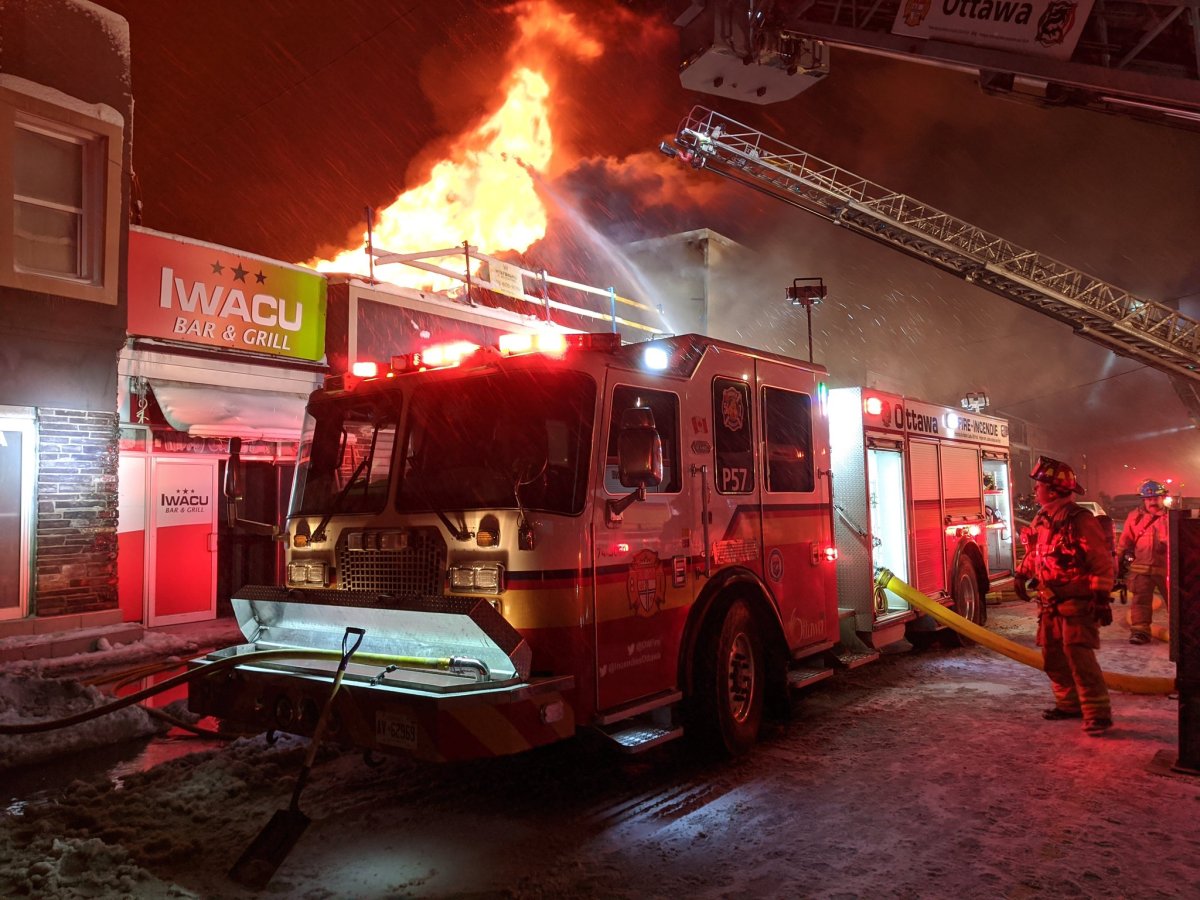 Ottawa firefighters battle a three-alarm blaze that broke out in a mixed-use building on Montreal Road in Vanier, east of downtown, on Thursday evening.