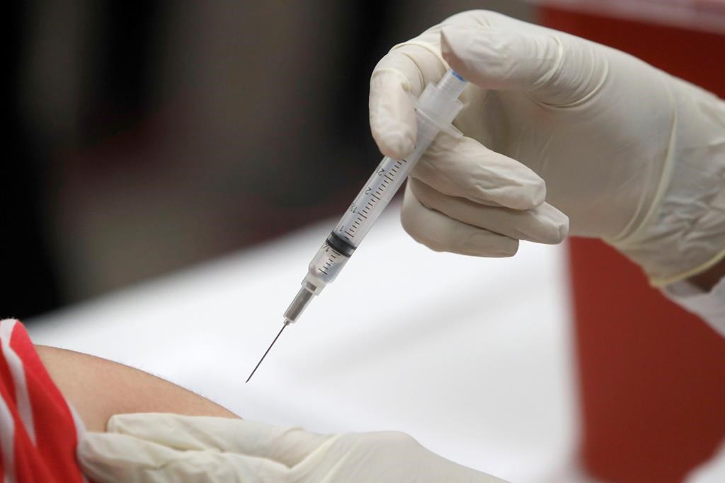 FILE - This Jan. 23, 2020 file photo shows a patient receiving a flu vaccination in Mesquite, Texas. 