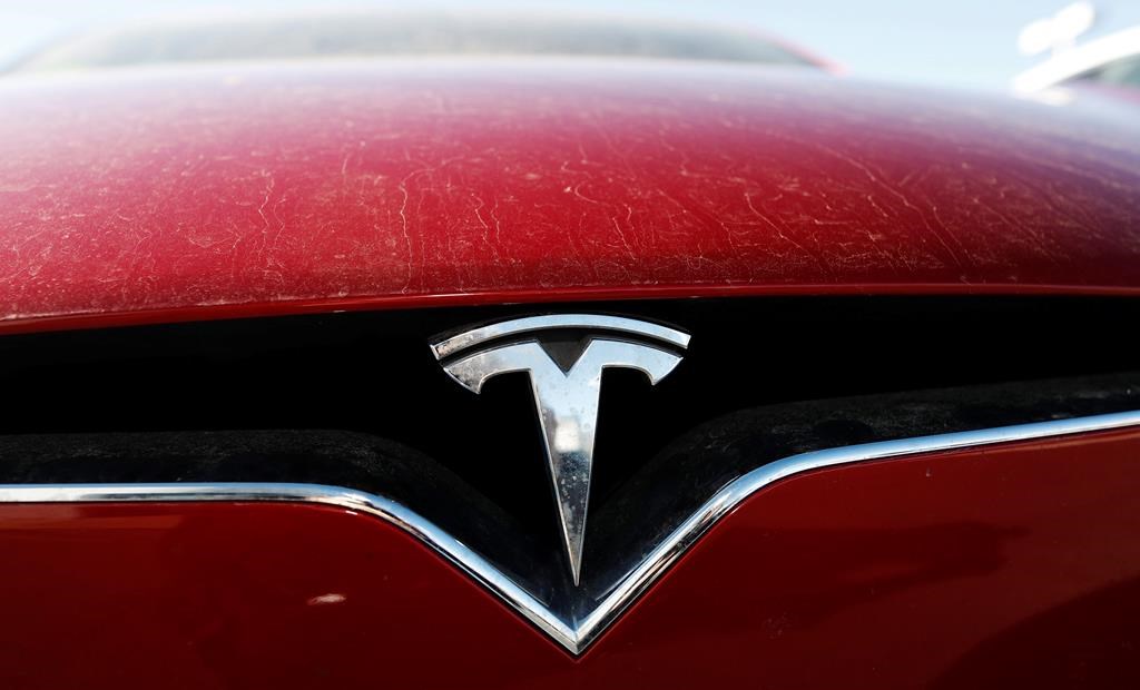 FILE - In this Feb. 2, 2020, file photo, the company logo shines on the grille of an unsold 2020 Model X at a Tesla dealership in Littleton, Colo. Tesla is now worth more than General Motors, Ford and Fiat Chrysler combined, even though the Big Three together sell more cars and trucks in two weeks than Tesla does in a whole year. (AP Photo/David Zalubowski, File).