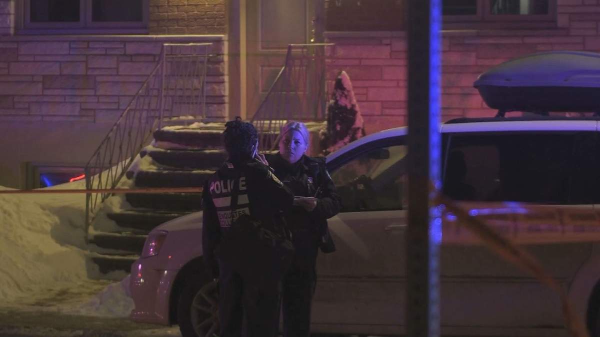 A Montreal police constable looks on at the site of a deadly collision between a car and a pedestrian in front of a private residence in the borough of Anjou on Feb. 12, 2020.