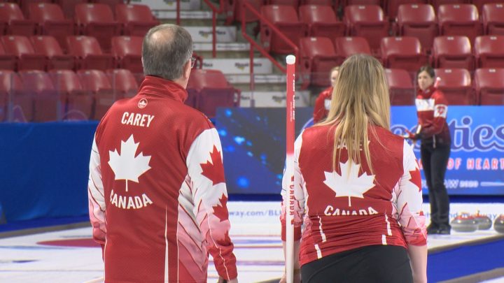 Dan and Chelsea Carey discuss strategy during practice at the 2020 Scotties Tournament of Hearts.
