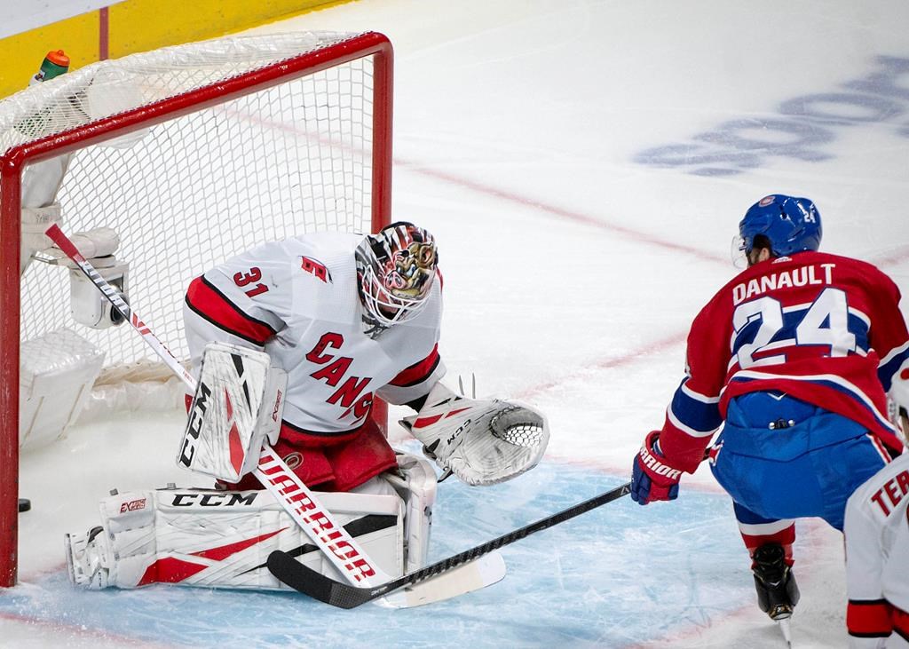 Montreal Canadiens centre Phillip Danault (24) scores on Carolina Hurricanes goaltender Anton Forsberg (31) during first-period NHL hockey action in Montreal, Saturday, Feb. 29, 2020.