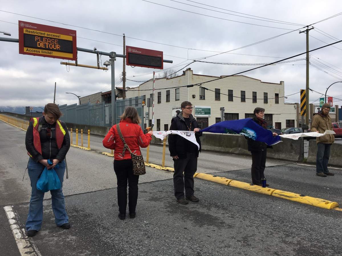 Protesters defy a court injunction and block the Clark Drive entrance to the Port of Vancouver on Wednesday, Feb. 26, 2020. 