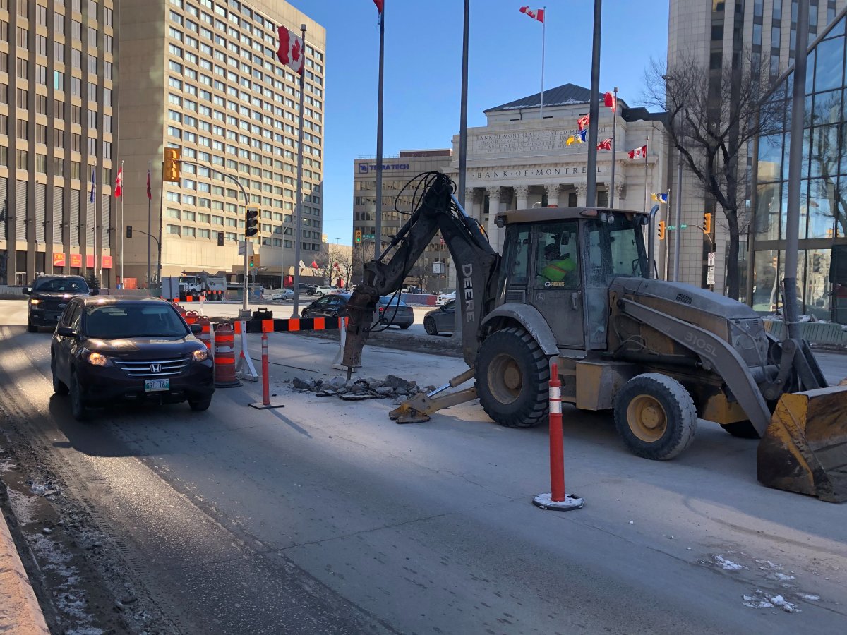 Crews work in front of 201 Portage Ave. on Sunday.
