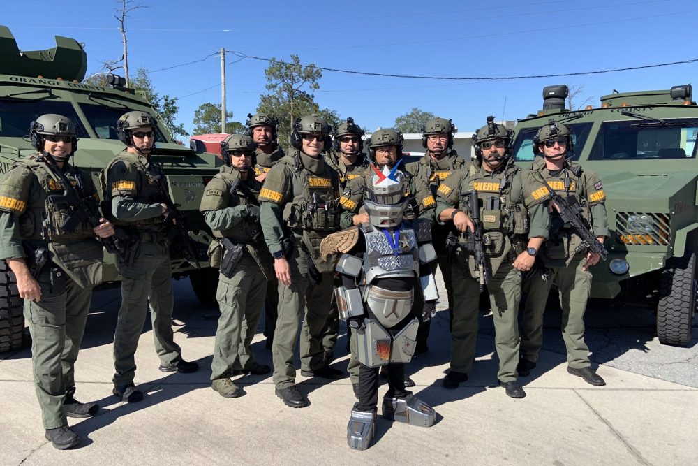 Gaige Pike, centre, is shown as ‘ROBOGaige’ alongside the Orange County Sheriff’s Office SWAT team in Orange County, Calif., on Feb. 27, 2020.