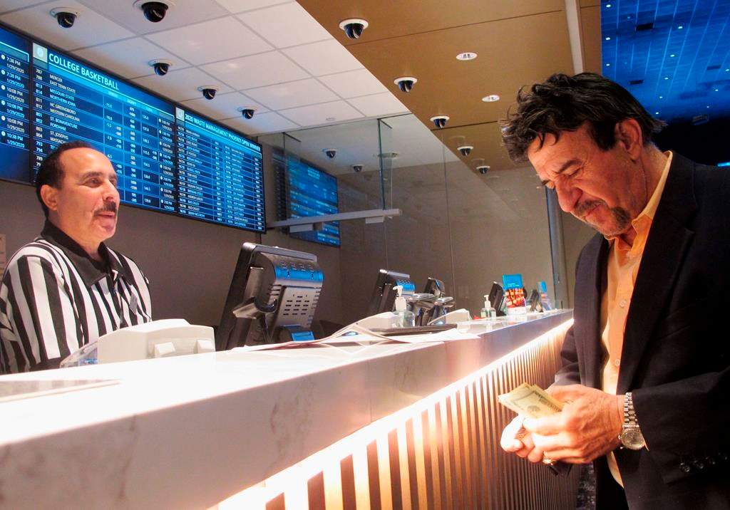 In this Jan. 29, 2020 photo, a man makes a bet on the upcoming Super Bowl at Bally's casino in Atlantic City,.