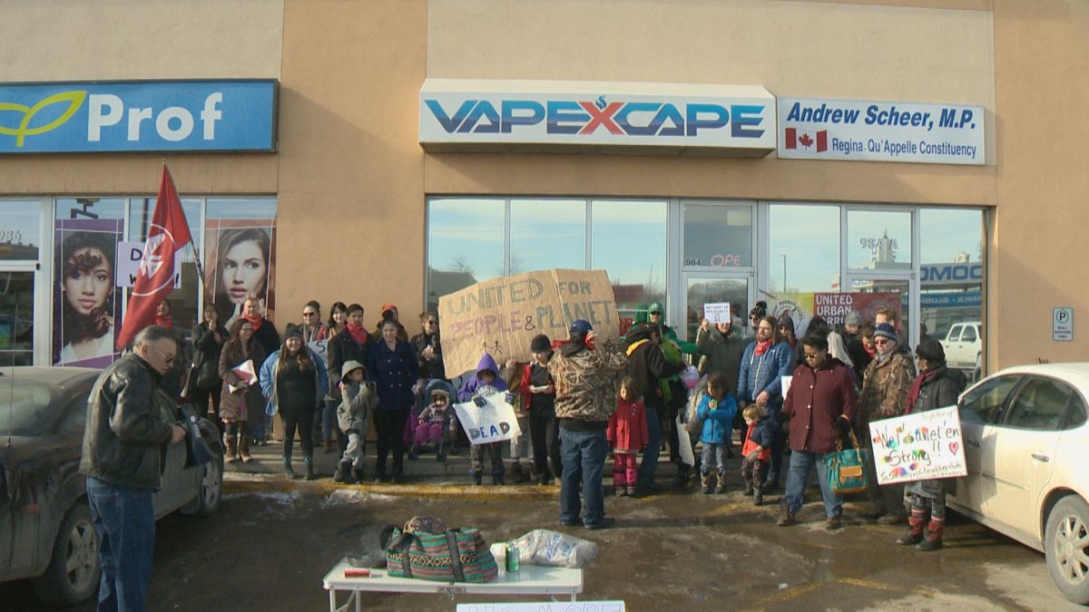 Protesters rally in front of Conservative Leader Andrew Scheer's constituency office in Regina on Feb. 22.