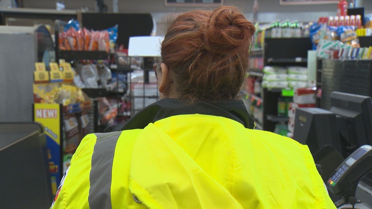 A security guard stands near the front door of Cantor's Meats in Winnipeg.