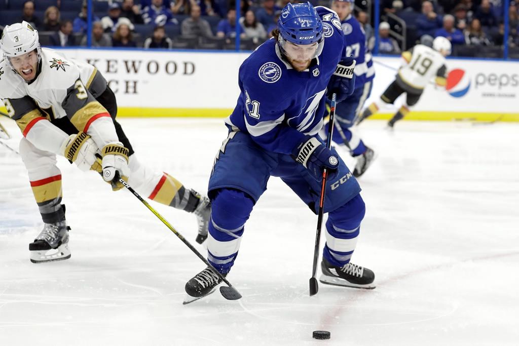Tampa Bay Lightning centre Brayden Point (21) loses the puck to a stick-check by Vegas Golden Knights defenceman Brayden McNabb (3) during the second period of an NHL hockey game Tuesday, Feb. 4, 2020, in Tampa, Fla.