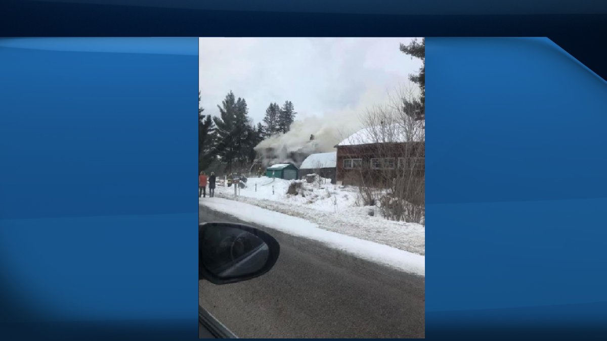 A person from Belleville is facing assault and arson charges after a house burned down in Tweed. 