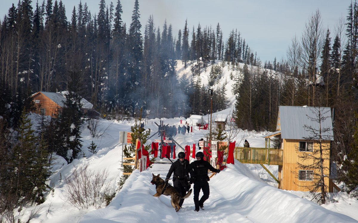 RCMP walk through the Unist'ot'en camp on Monday, Feb. 10, 2020, as they conclude a five-day enforcement of a court injunction clearing access to the area for gas pipeline crews. 