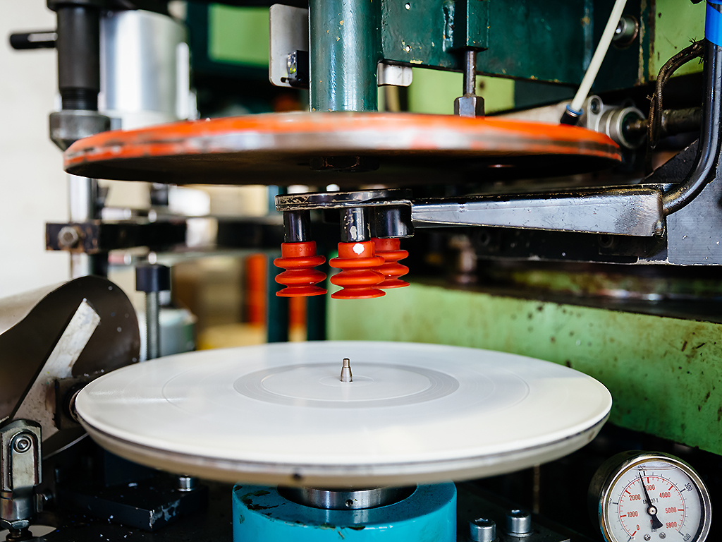 Close-up shot of a pressing machine for vinyl records.