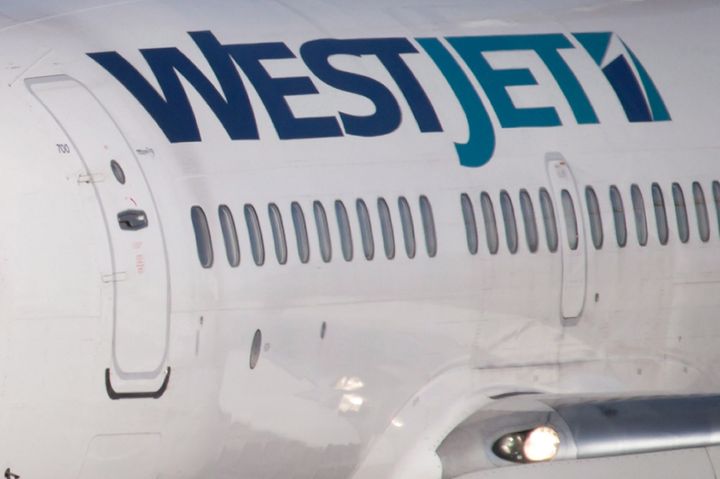A pilot taxis a Westjet Boeing 737-700 plane to a gate after arriving at Vancouver International Airport in Richmond, B.C., on Monday February 3, 2014.